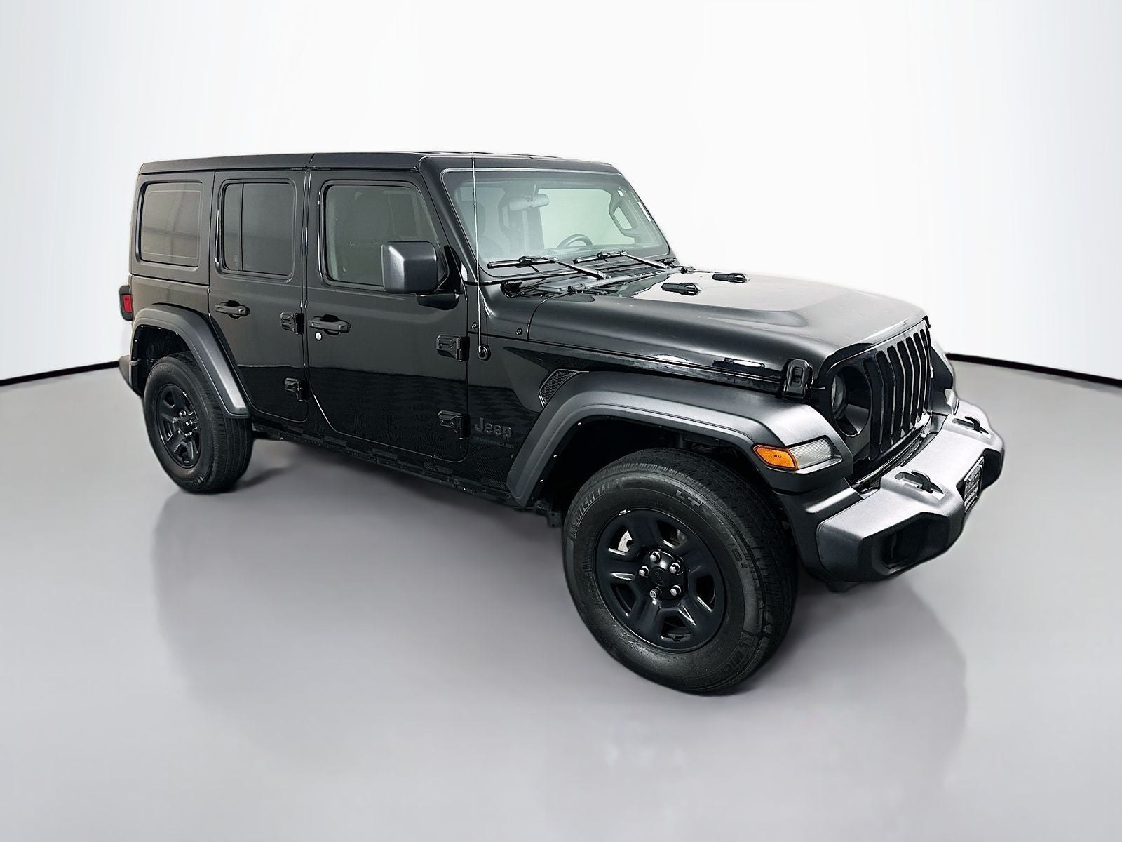 2023 Jeep Wrangler 4-Door Sport 4x4 in Black Clearcoat — front three-quarter view