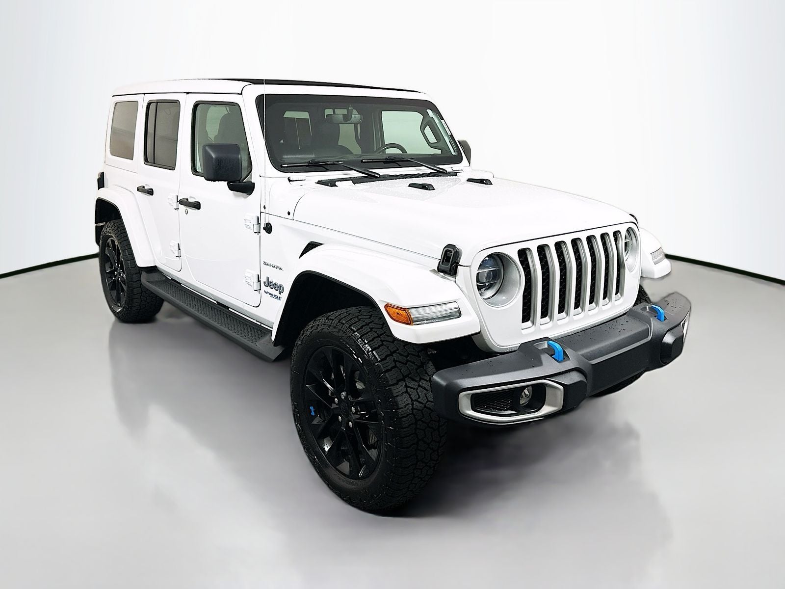 2022 Jeep Wrangler 4xe Unlimited Sahara 4x4 in Bright White Clearcoat — front three-quarter view
