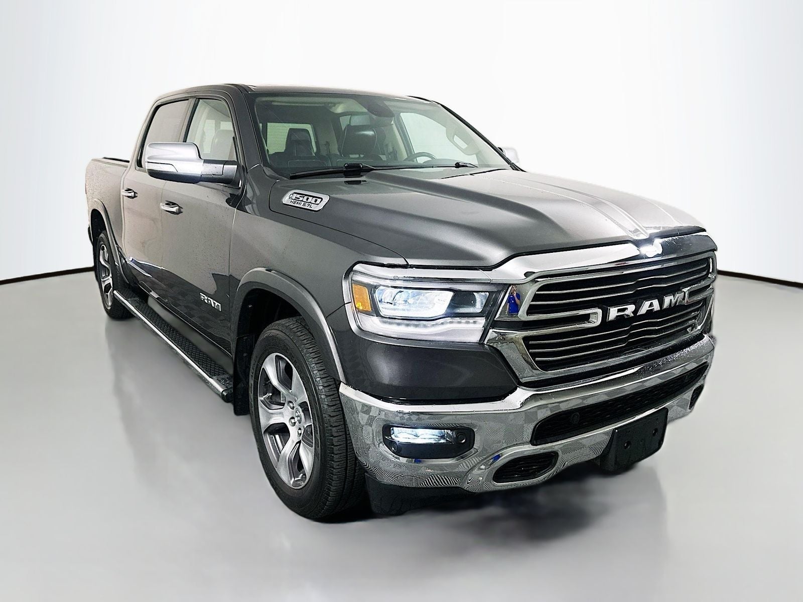 2019 RAM 1500 Laramie Crew Cab 4x4 5'7' Box in Granite Crystal Metallic Clearcoat — front three-quarter view
