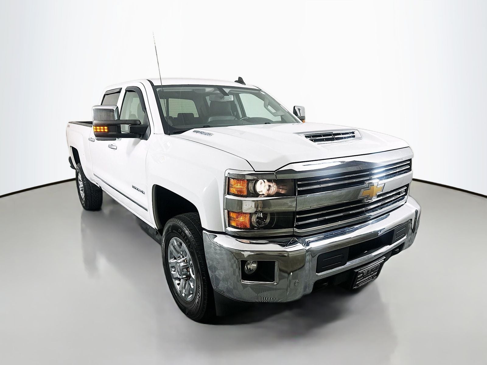 2018 Chevrolet Silverado 2500HD LTZ in Summit White — front three-quarter view