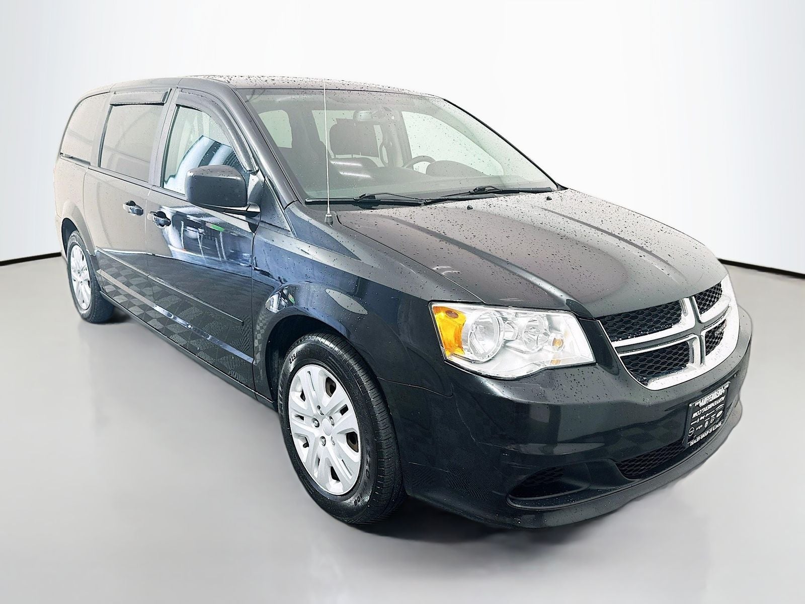 2017 Dodge Grand Caravan SE in Black Onyx Crystal Pearlcoat — front three-quarter view
