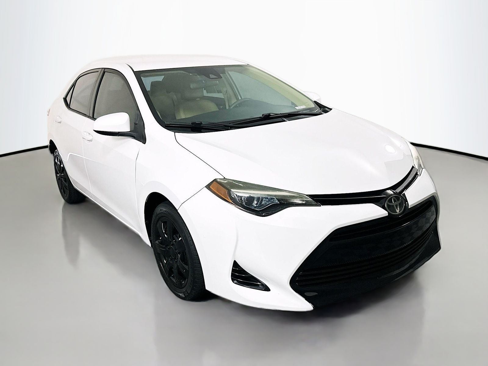 2018 Toyota Corolla LE in Super White — front three-quarter view