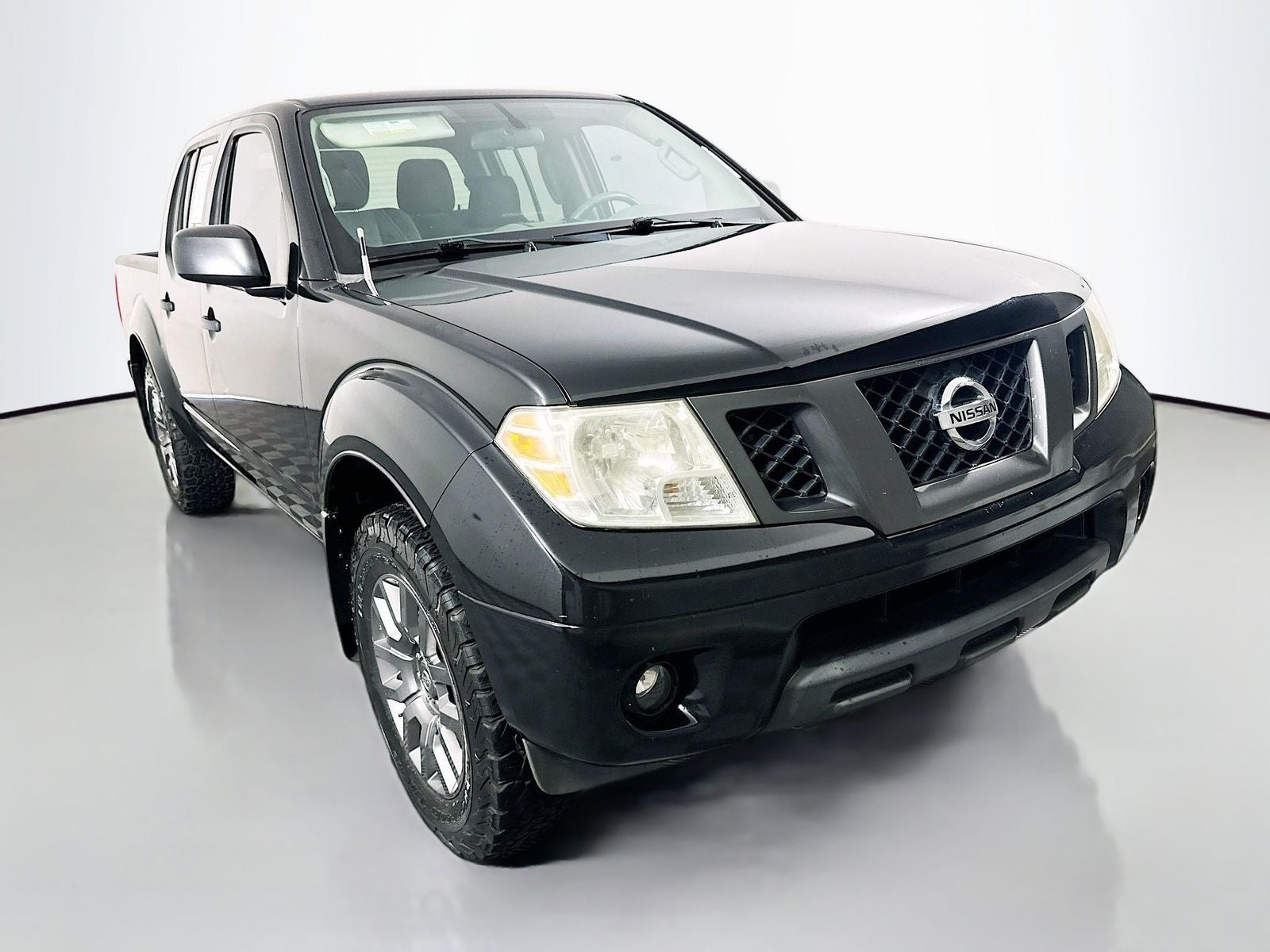 2012 Nissan Frontier SV in Super Black Metallic — front three-quarter view