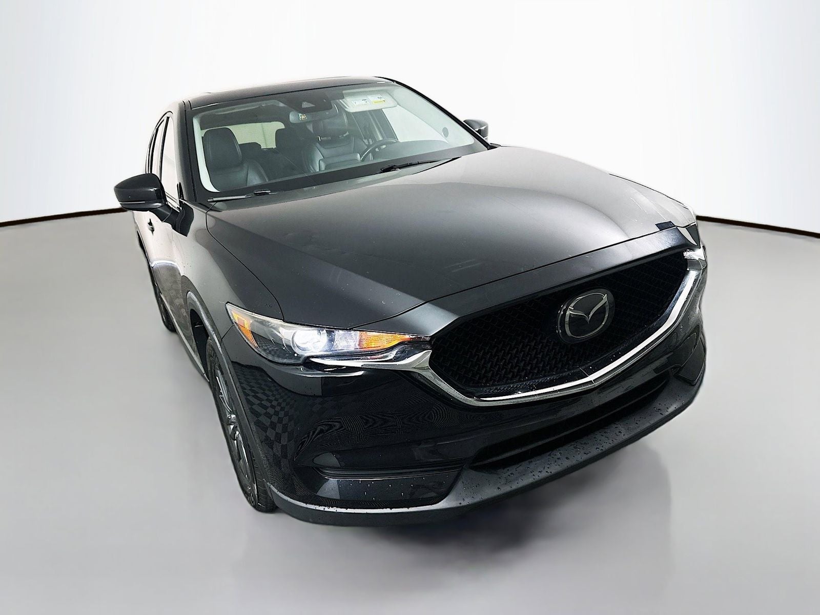 2019 Mazda Mazda CX-5 Touring in Jet Black Mica — front three-quarter view