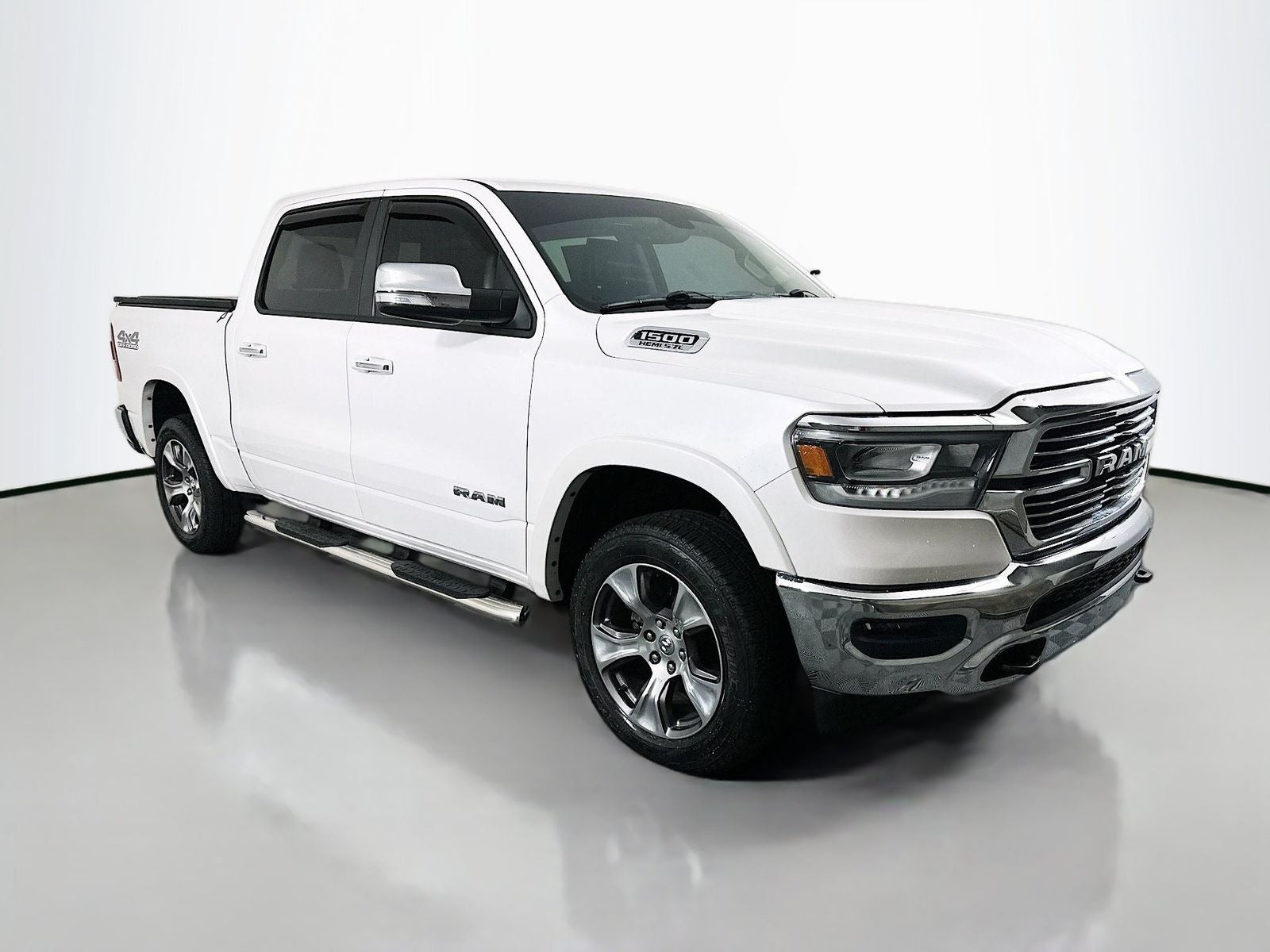 2020 RAM 1500 Laramie in Ivory White Tri-Coat Pearlcoat — front three-quarter view