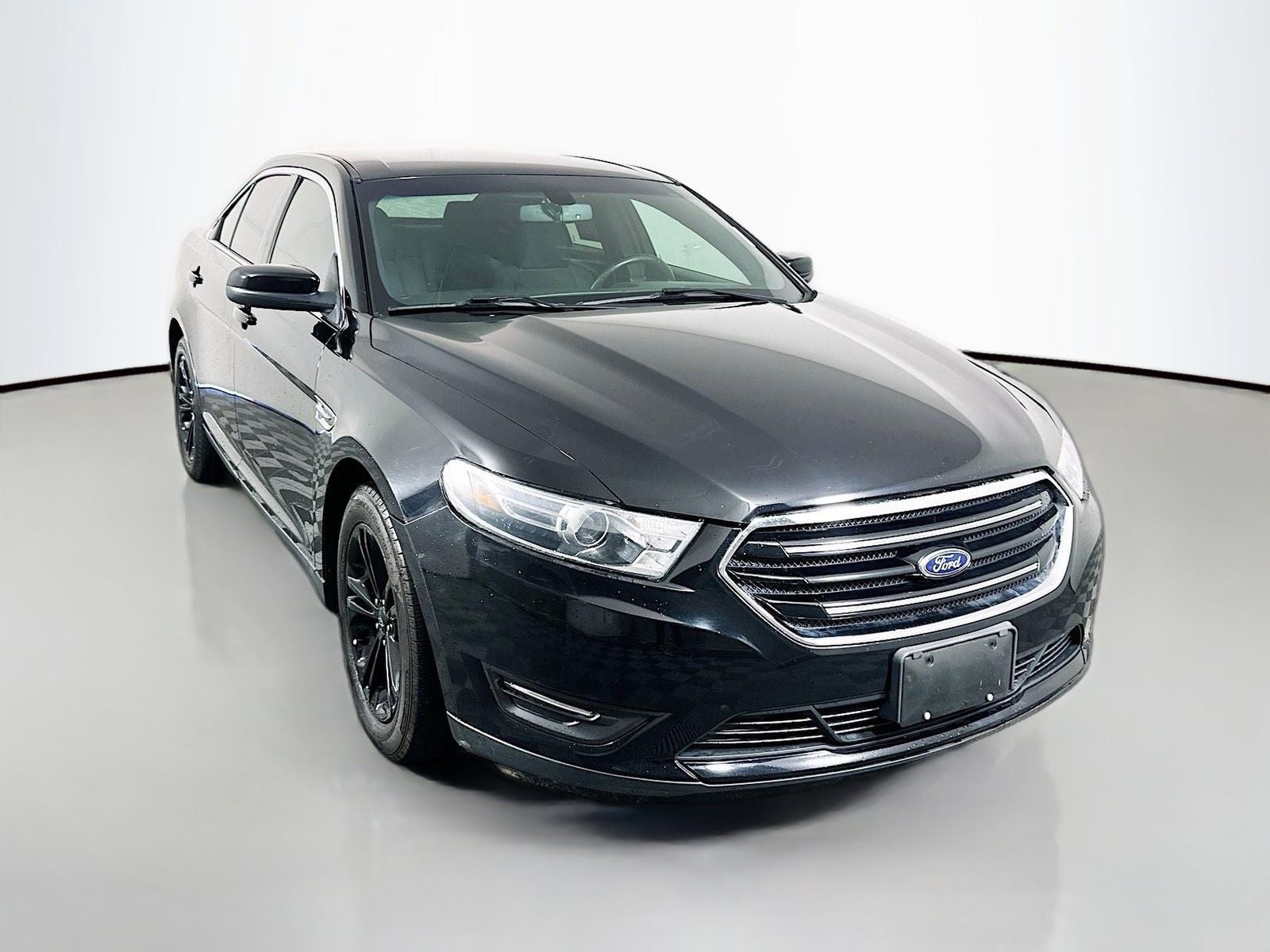 2016 Ford Taurus SEL in Shadow Black — front three-quarter view