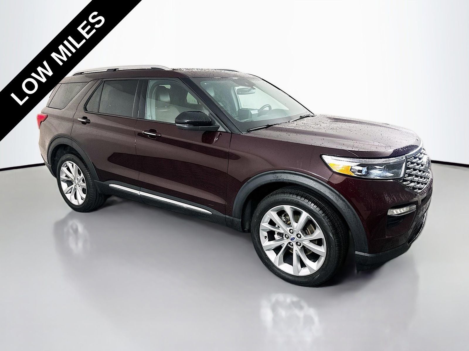 2023 Ford Explorer Platinum in Jewel Red Metallic Tinted Clearcoat — front three-quarter view