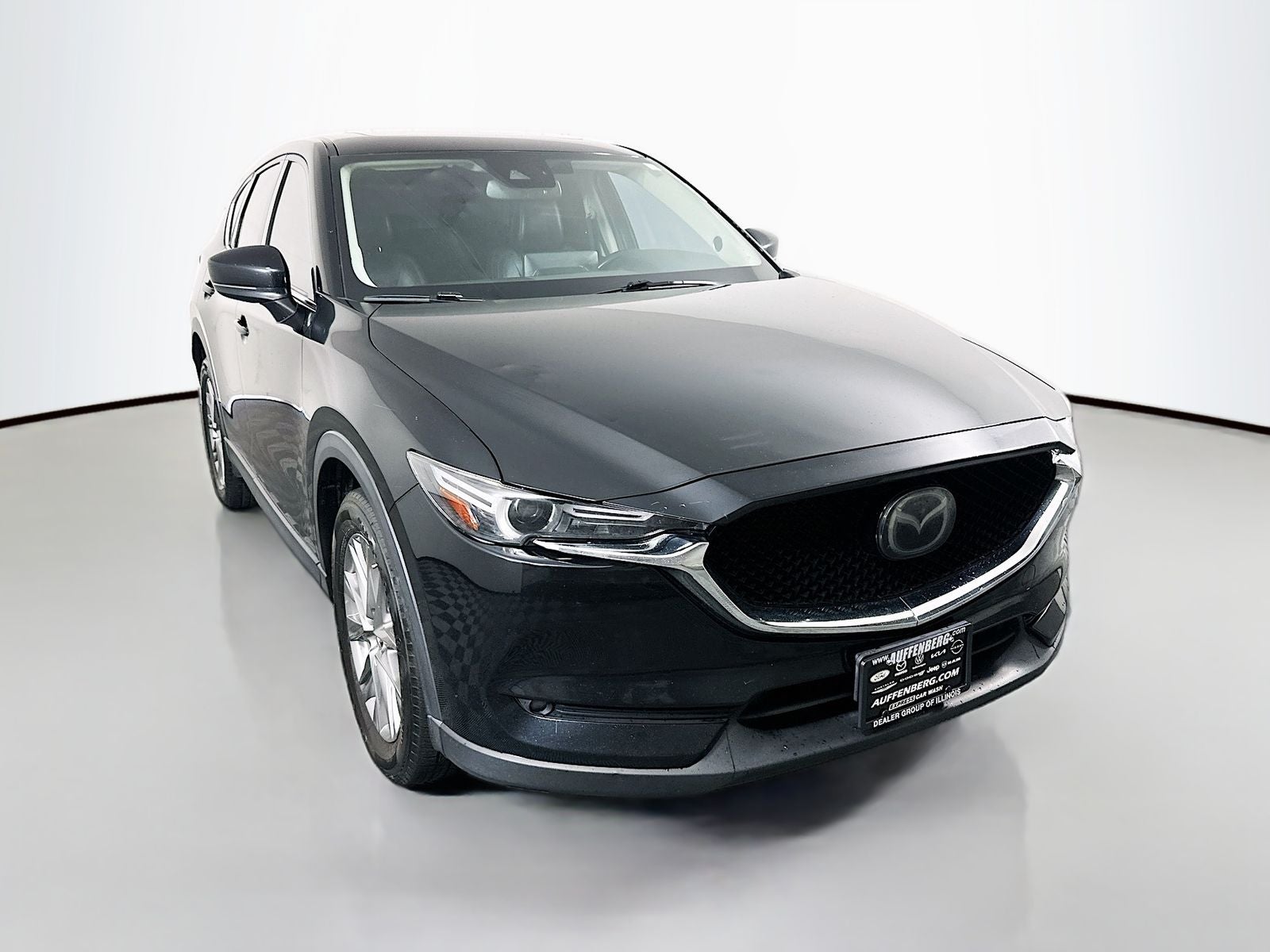 2021 Mazda Mazda CX-5 Grand Touring in Jet Black Mica — front three-quarter view