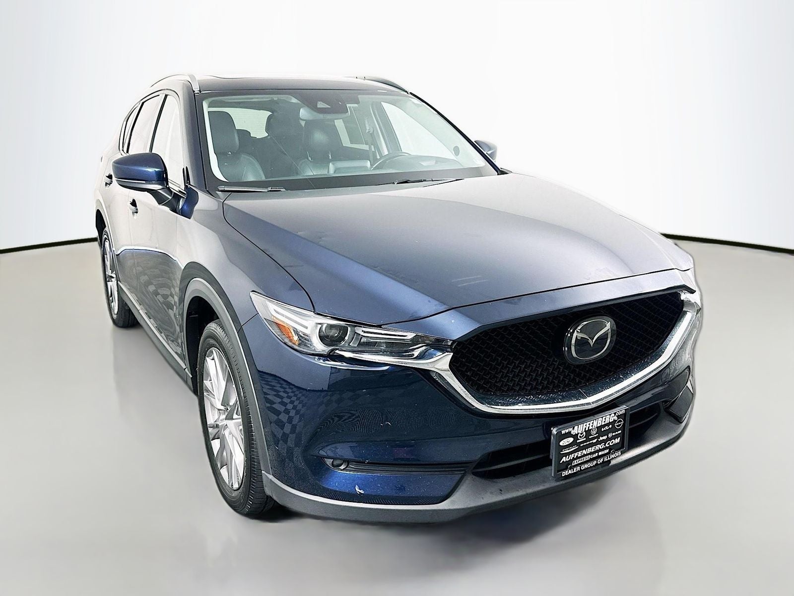 2019 Mazda Mazda CX-5 Grand Touring in Deep Crystal Blue Mica — front three-quarter view