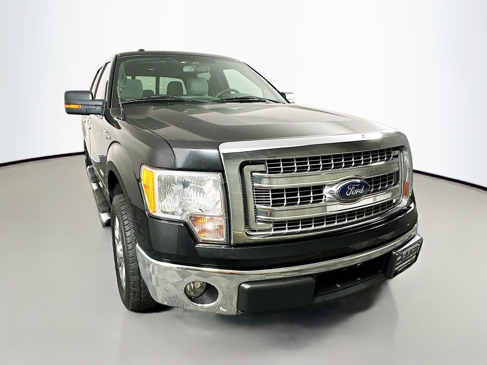2014 Ford F-150 XLT in Tuxedo Black Metallic — front three-quarter view