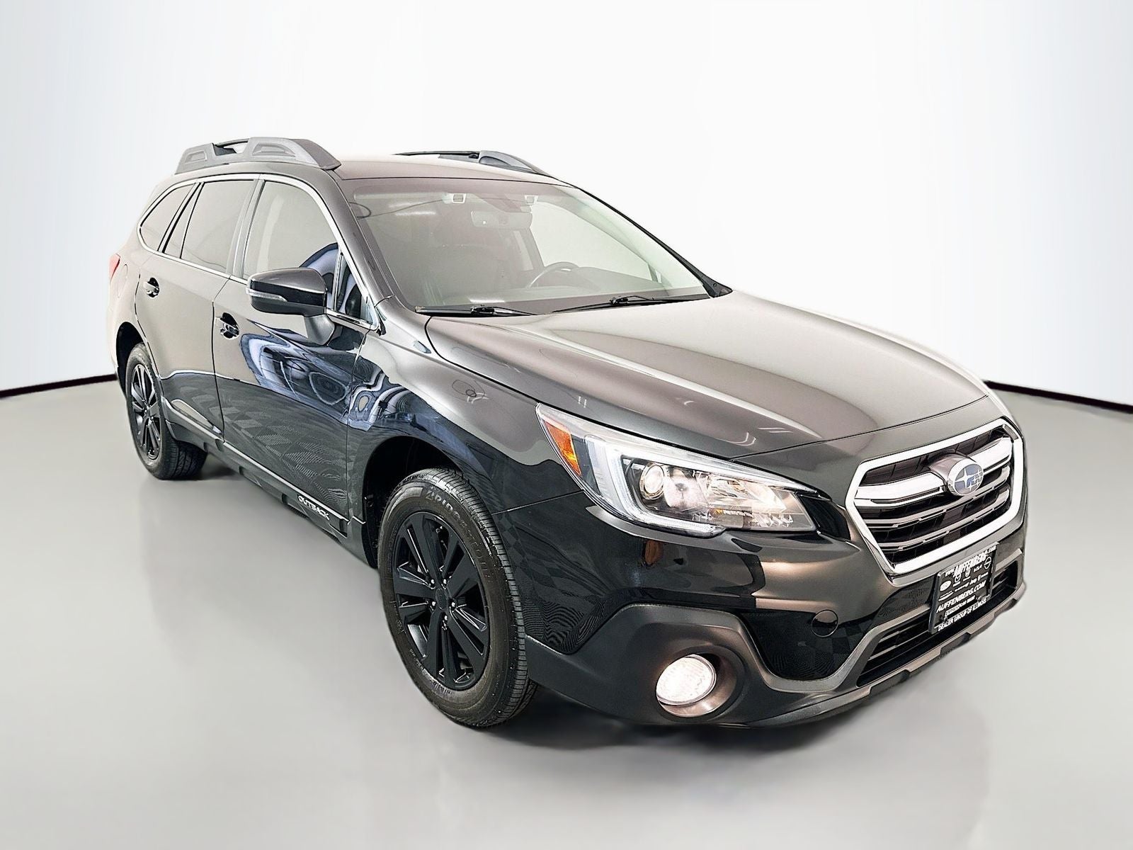2019 Subaru Outback Limited in Crystal Black Silica — front three-quarter view