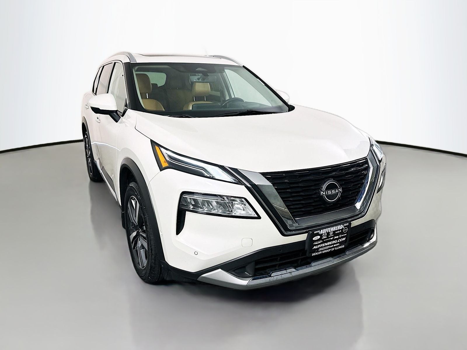 2023 Nissan Rogue Platinum in Pearl White Tricoat — front three-quarter view